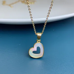 Close-up detail of the elegant natural white mother-of-pearl hollow heart pendant necklace.