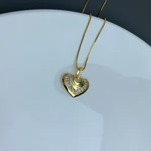 Exquisite micro-set rhinestone heart necklace detail, elegant gold clavicle chain pendant.