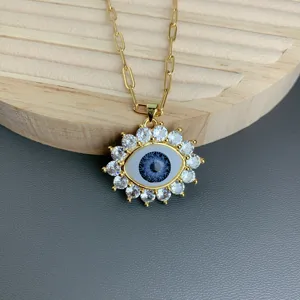 Detail view of the stylish evil eye pendant necklace featuring sparkling cubic zirconia stones.