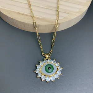 Gold chain necklace featuring a stunning green evil eye pendant with cubic zirconia stones.