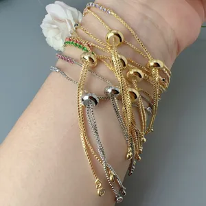 Detailed view of multi-layer adjustable slider bracelets with colorful cubic zirconia.