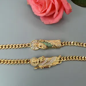 Detailed close-up view of gold-plated Cuban link bracelets featuring sparkling crystal zircon religious pendants.