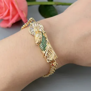 Gold Cuban chain bracelet featuring a crystal zircon portrait pendant, elegant detail jewelry.