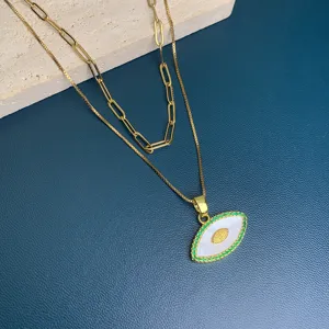 Double layer evil eye pendant necklace featuring white mother of pearl and green stone pave.