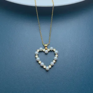 detail view of gold chain necklace with faux pearl rhinestone heart pendant elegant fashion