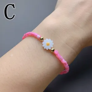 Chic pink beaded bracelet with white shell daisy flower and gold beads for women daily wear