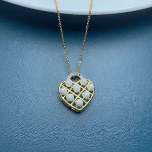 Elegant gold-tone heart pendant necklace featuring faux pearls and rhinestones details.