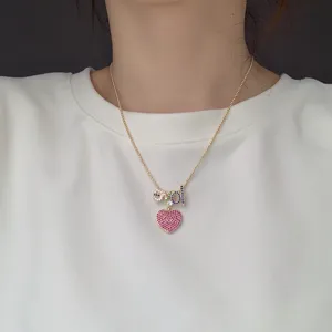 Gold beaded chain necklace with colorful zircon letter and pink heart pendant for women.