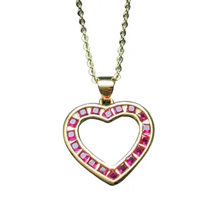 Gold-tone heart pendant necklace featuring square-cut red stones on a delicate chain.