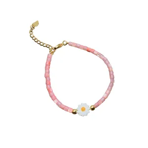 Pink shell beaded bracelet with white daisy flower charm, gold clasp and extension chain main view
