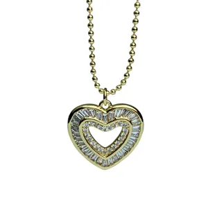 Gold double heart pendant necklace with shimmering zircon rhinestones and delicate beaded chain.