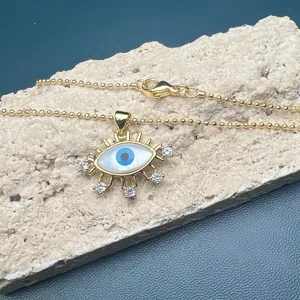 Exquisite detail view of gold-plated evil eye pendant necklace with shimmering cubic zirconia.