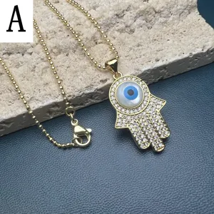Gold Plated Hamsa Hand Evil Eye Necklace with Mother of Pearl Pave Crystal Pendant