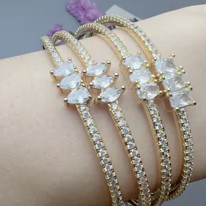 Detailed view of fashion geometric zircon gold cuff bracelets, elegant women wrist jewelry.