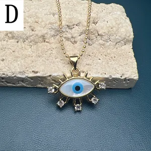 Close-up of the elegant evil eye pendant necklace with mother-of-pearl and crystal details.