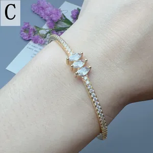 Elegant gold-tone open cuff bracelet featuring marquise zirconia stones for women.