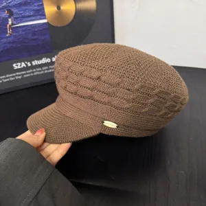 Retro knitted newsboy cap for women, vintage flat top beret with metal tag, brown.