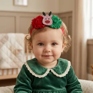 Close-up detail of cute Christmas baby headband with red green flower and glitter reindeer.