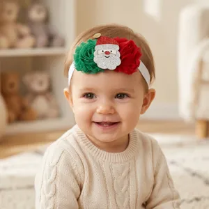 Cute baby Christmas headband detail, featuring red and green flowers with glitter Santa Claus.