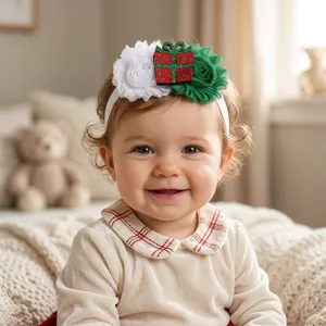 Cute Christmas baby headband with gift box and flower decor, soft elastic hair accessory.