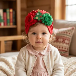 Detailed shot of a cute baby wearing a festive red Christmas turban hat with flower decor.