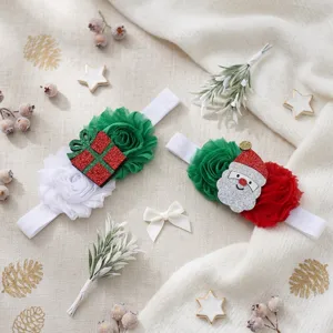 Christmas baby headband detail view featuring cute Santa and gift box chiffon flower designs.