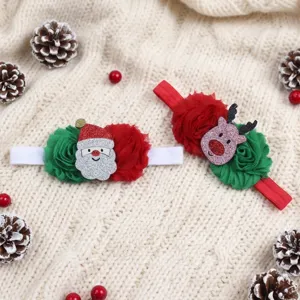 Detailed view of cute Christmas baby headband with Santa and reindeer cartoon ornaments.