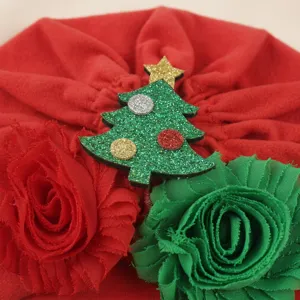 Baby Christmas flower turban detail shot, cute newborn red hat with glitter tree.