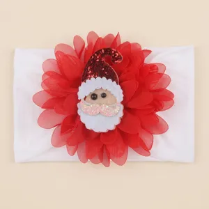 Christmas baby headband detail showing red chiffon flower and cute Santa Claus face ornament.