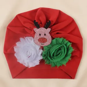 Detailed view of the Christmas baby turban hat featuring reindeer and flower decor.