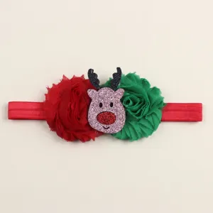 Christmas baby headband detail shot featuring red green flowers and glitter reindeer ornament.