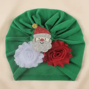 Cute Christmas baby turban hat with Santa and flower design, soft infant cap for holiday.