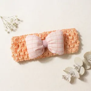 Detailed view of the cute baby crochet headband with a soft checkered bow for infants.