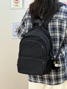 Japanese minimalist black nylon backpack for women daily casual school bag with cat pendant.