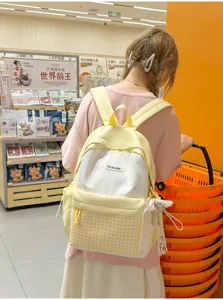 Japanese sweet style yellow polka dot backpack with plaid pocket and lace pendant for daily use.