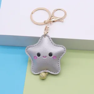 Cute star leather keychain detail, soft PU star pendant with metal ring and tiny gold bell charm.