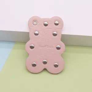 Pink bear leather bag charm with metal rivets, cute cartoon keychain pendant for handbags.