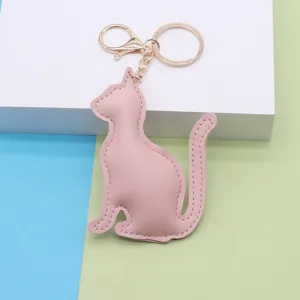 Cute pink PU leather cat keychain with gold metal hardware for chic bag charms and gifts.