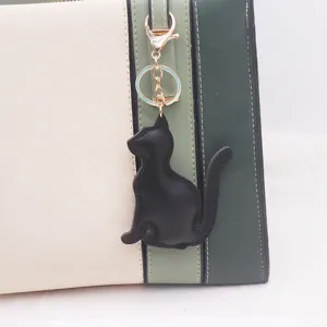PU leather cat keychain, cute black kitty bag charm pendant, simple minimalist fashion accessory.