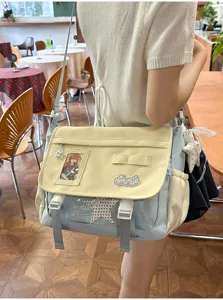 Japanese style colorblock messenger ita bag with clear window and cute badges for daily wear.