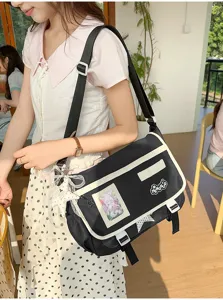 Japanese style sweet contrast color messenger ita bag with clear window and cute pendants for daily commute.