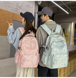 Detailed view of casual couple star print backpack, practical multi-compartment school bag.