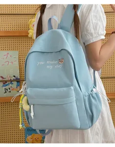 Cute light blue school backpack with sweet embroidery and side pockets for casual daily use.
