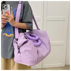 Detail view of a soft taro purple duffel bag, showing texture and large capacity style.