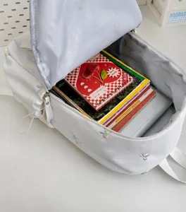Canvas casual school backpack with colorful bow embroidery, spacious interior for daily use.