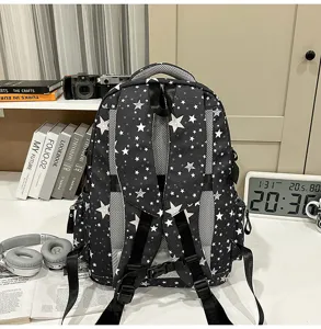 Detailed view of the trendy black star-patterned backpack with breathable shoulder straps.