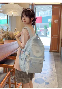 Lightweight blue cartoon print backpack with lace pendant, cute style for casual and school daily use.