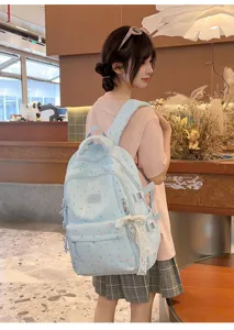 Light blue cute cartoon school backpack for teen girls, casual daypack with cute bow pendant.