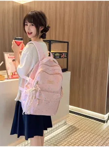 Cute pink backpack for women, sweet star pattern school bag with lace bow pendant for daily use.