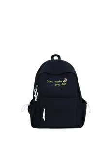 Stylish dark canvas backpack with front embroidery and drawstring details for daily school use.